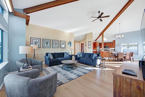 a living room with blue couches and a table at Eagle's Nest in Bodega Bay