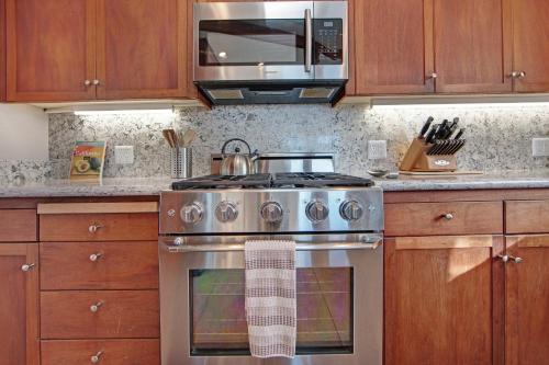 a kitchen with a stainless steel stove and a microwave at Eagle's Nest in Bodega Bay