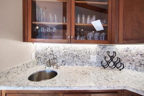 a kitchen counter with a sink and wooden cabinets at Eagle's Nest in Bodega Bay
