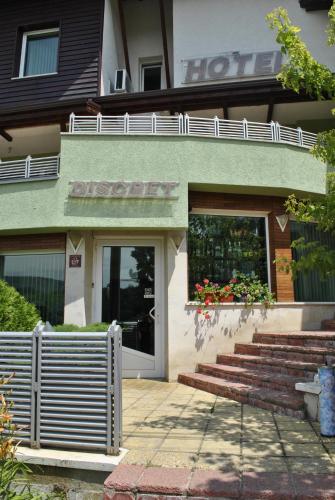a hotel with a sign on the front of a building at Discret Hotel & Restaurant in Vladaya