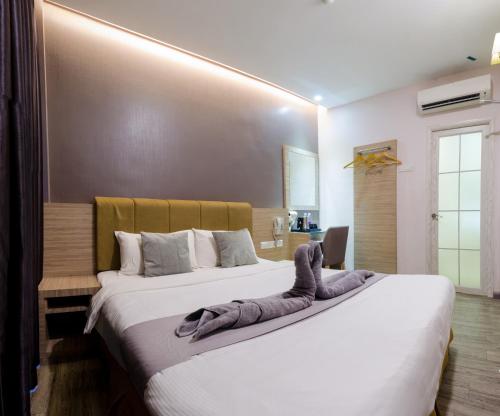 a bedroom with two beds with towels on them at GM Grand Moments Bandar Sunway in Petaling Jaya
