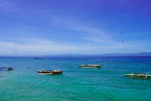 a group of boats in the water at MLK Bamboo Beachhouse in Alegria