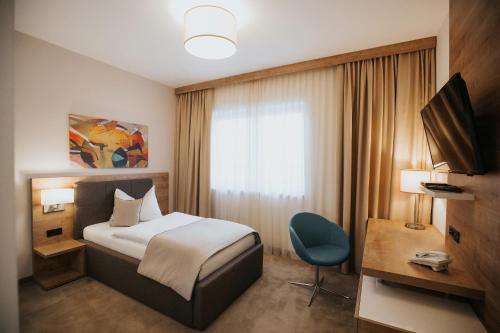 En eller flere senger på et rom på Hotel Zelenkrov