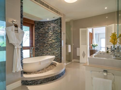 a bathroom with a large tub and a sink at Villa Macaque and Villa Languor in Railay Beach