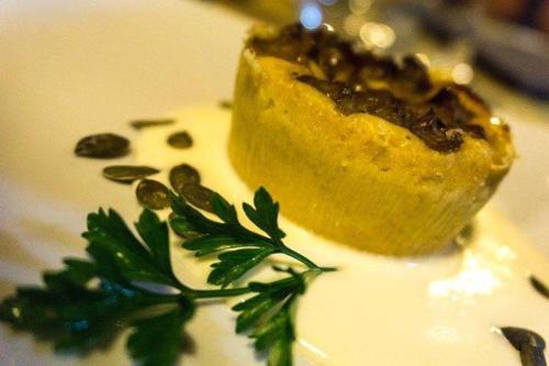 a piece of pie on a white plate with green leaves at Bio Agriturismo Il Melograno di Banditella Ristorante in Alberese