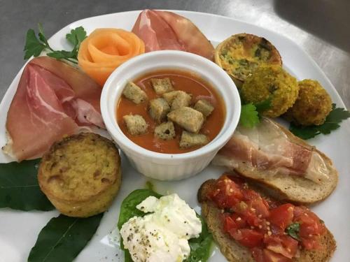 a plate of food with a bowl of soup at Bio Agriturismo Il Melograno di Banditella Ristorante in Alberese