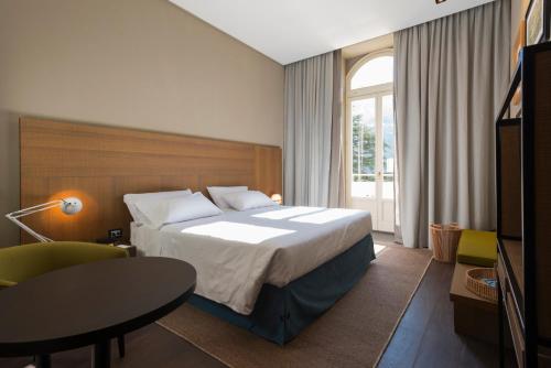 Postel nebo postele na pokoji v ubytování Grand Hotel Billia