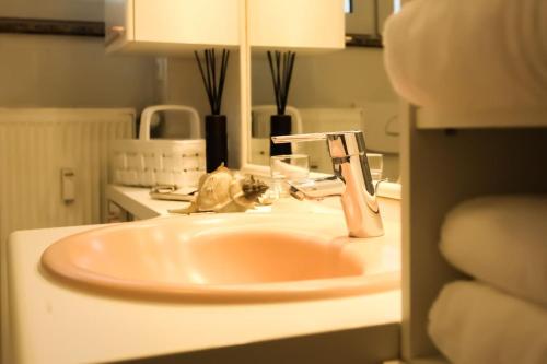 a bathroom sink with a faucet on top of it at Kant-Haus in Viernheim