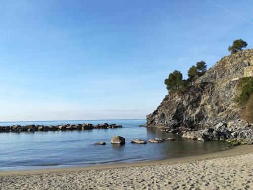 a beach near the ocean with rocks in the water at Casa Anna in Moneglia