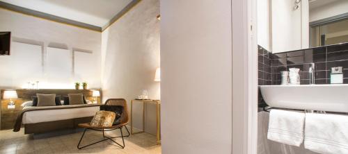 a bathroom with a sink and a bed in a room at Palazzo del Papa in Siena
