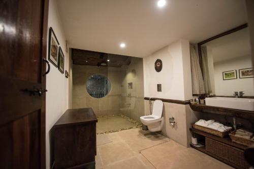 a bathroom with a toilet and a sink and a shower at Forsyth Lodge in Sohāgpur