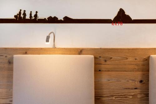 a kitchen with a sink and a shelf with figurines at Annex Antika in Zermatt