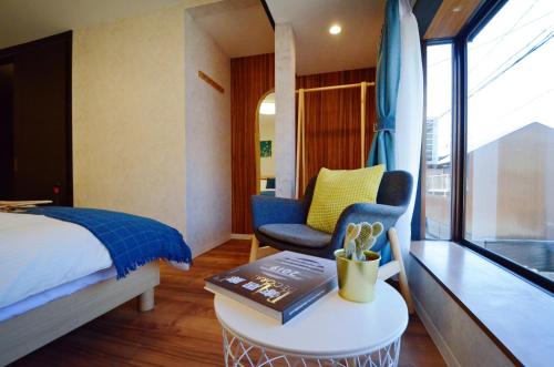 a hotel room with a bed and a table with a book at Yamato Family House - 2 Floors | 3 bedrooms in Osaka