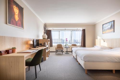 Postel nebo postele na pokoji v ubytování Hotel Carlton