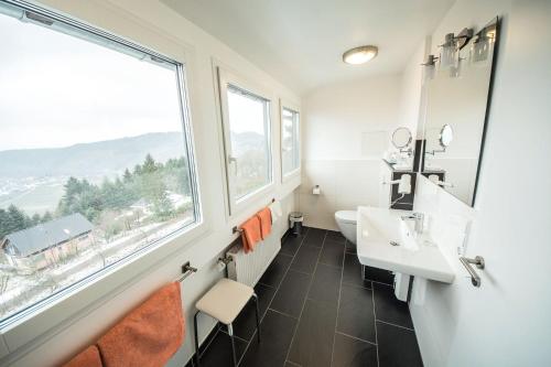 a bathroom with a sink and a window at Gästehaus-Weingut Loersch in Leiwen
