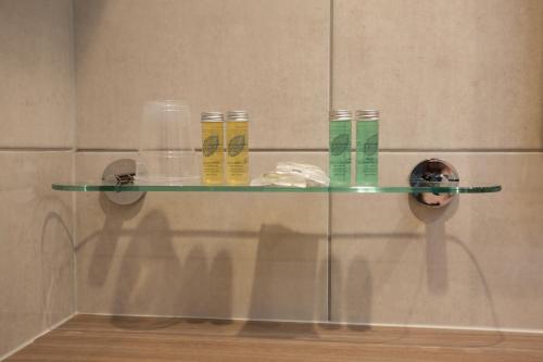 a glass shelf on a wall in a bathroom at Cruachan Hotel in Fort William