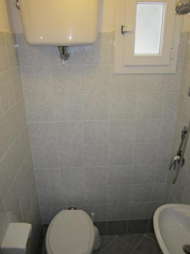 a bathroom with a white toilet and a sink at Le Case dei Pescatori - Albicocco in Ponza