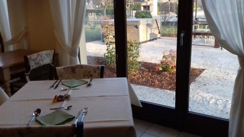 a dining room table with two chairs and a window at Agriturismo Otto Ducati D'Oro in Isola della Scala