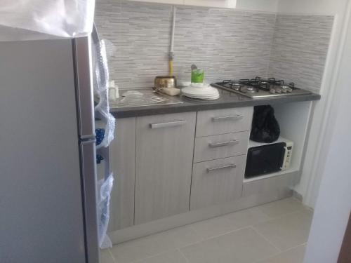 a kitchen with a sink and a stove top oven at Ikamet Rihab at Hammamet North in Nabeul