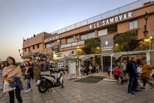 a group of people walking on a street in front of a building at BnB MEDINA in Marrakech