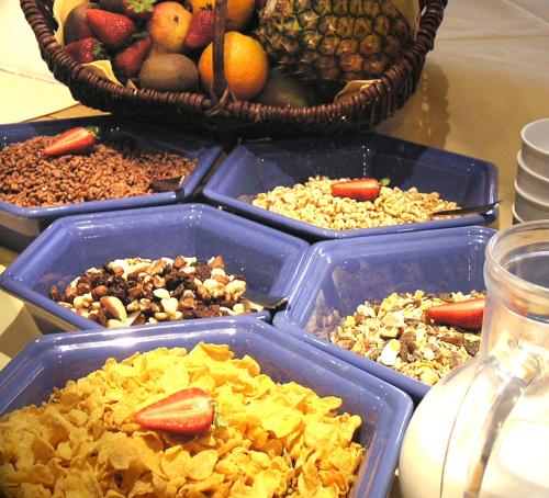 a table with four blue trays of different types of food at Hotel zur Post in Kreuth
