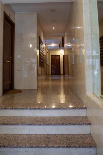 a hallway of a building with stairs and a door at Apartamentos Duque Ventas in Madrid