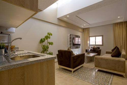 a kitchen with a sink and a living room at BnB MEDINA in Marrakech