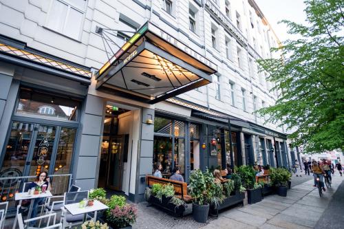 a restaurant with people sitting outside of a building at The Circus Hostel in Berlin