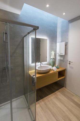 a bathroom with a sink and a shower at Azaleas Guest House in Ribeira Chã