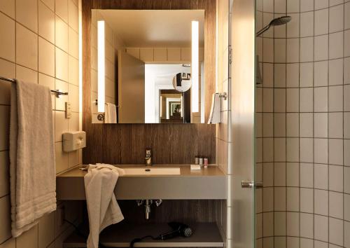 bagno con lavandino e specchio di Comwell Borupgaard a Snekkersten