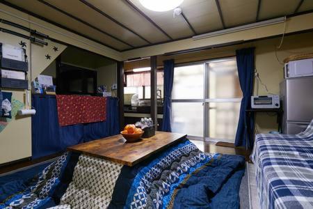 a bedroom with a table with a bowl of fruit on it at Yokohama Sakae-chou Ninja House #JA1 in Yokohama