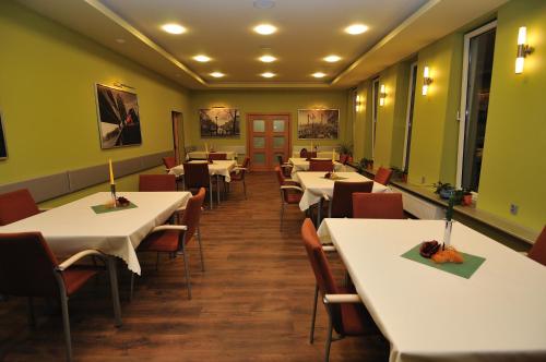 a dining room with white tables and chairs at HOSTEL SUCHY BÓR in Suchy Bór