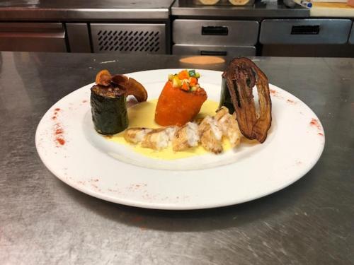 a white plate of food on a table at Hôtel La Bastide in Hyères