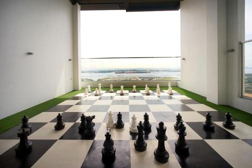 a chess board in a room with a window at 5min Permas@CIQ@CS@3R2B@Green Haven in Masai