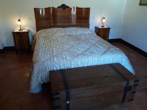 a bedroom with a large bed with two night stands at Agriturismo La Mela in Collevalenza