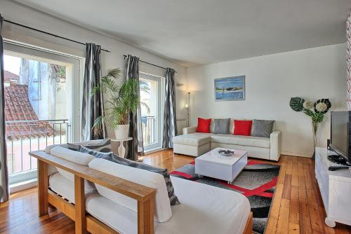 a living room with a couch and a table at MyPlaceLisbon - Bairro Alto Apartment in Lisbon
