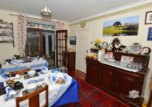 a dining room with two tables and a buffet at Rosedale Bed and Breakfast in Lyndhurst