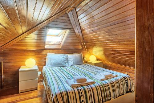 a bedroom with a bed in a wooden house at MyPlaceLisbon - Alfama River View Apartment in Lisbon