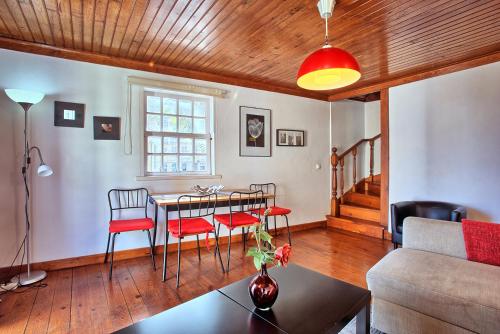 a living room with a table and chairs and a couch at MyPlaceLisbon - Alfama River View Apartment in Lisbon