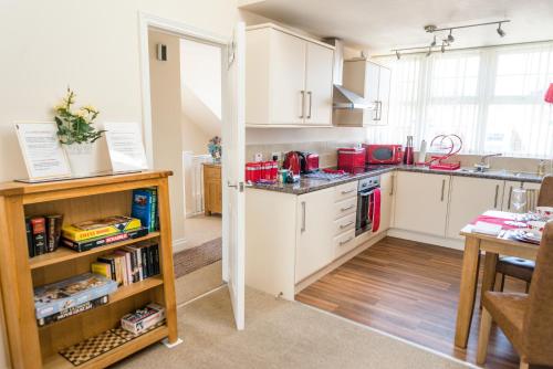 a kitchen with white cabinets and a counter top at The Upper Bakery in Cromer