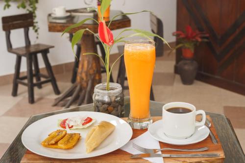une table avec une assiette de nourriture et une tasse de café dans l'établissement Country Club Eco Casajardin, à Moyobamba