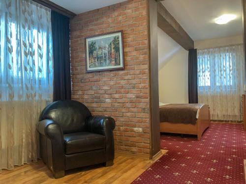 a living room with a chair and a brick wall at Villa Vodno in Skopje