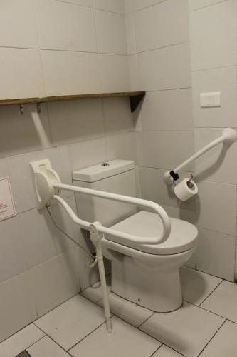 a bathroom with a toilet with a toilet paper dispenser at Hamra Urban Gardens in Beirut