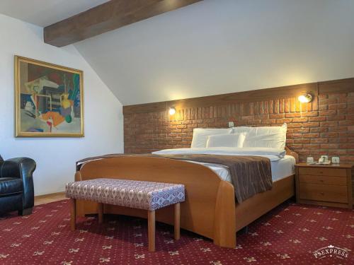 a bedroom with a large bed with a brick wall at Villa Vodno in Skopje