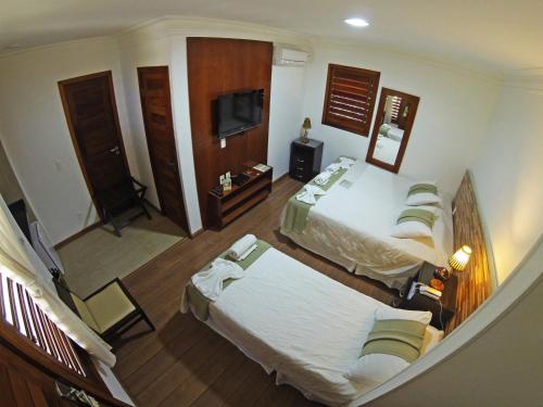 Postel nebo postele na pokoji v ubytování Hotel Vale das Nuvens