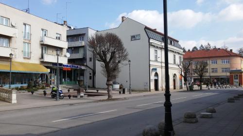 an empty street in a city with buildings at Apartman Lux in Daruvar