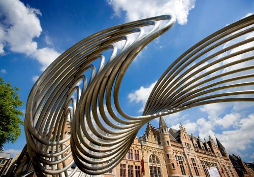 a metal sculpture in front of a building at ibis Kortrijk Centrum in Kortrijk