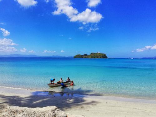 a group of people in a boat on the beach at Acuario Beach Inn in San Vicente
