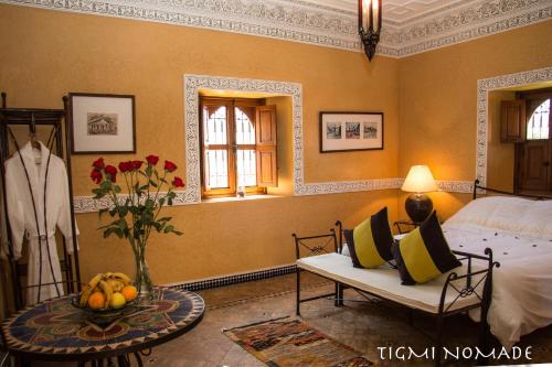 a bedroom with a bed and a table with fruit on it at Tigmi Nomade in Tahannout