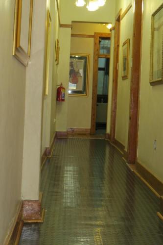 an empty hallway in an old building with wooden floors at Lajava Guest Lodge in Krugersdorp